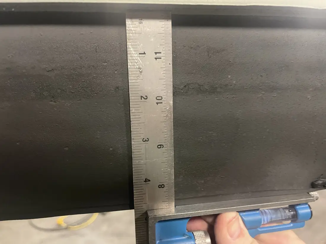 Measuring elastomer thickness against the rule